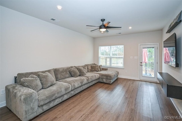 living room with hardwood / wood-style flooring and ceiling fan