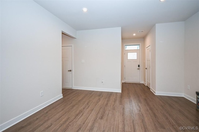 empty room with dark hardwood / wood-style flooring