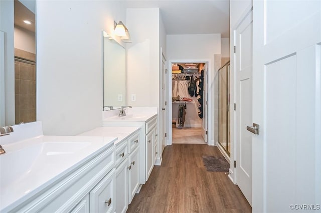 bathroom with vanity, hardwood / wood-style flooring, and an enclosed shower