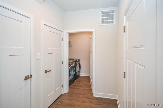 washroom with washer and clothes dryer and dark hardwood / wood-style flooring