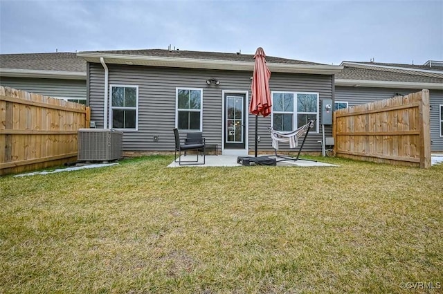 back of property with cooling unit, a patio, and a lawn