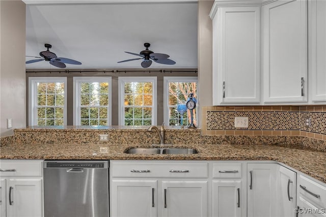 kitchen with stone countertops, sink, stainless steel dishwasher, and white cabinets