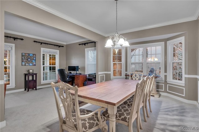 carpeted dining space with crown molding, a wealth of natural light, and a chandelier