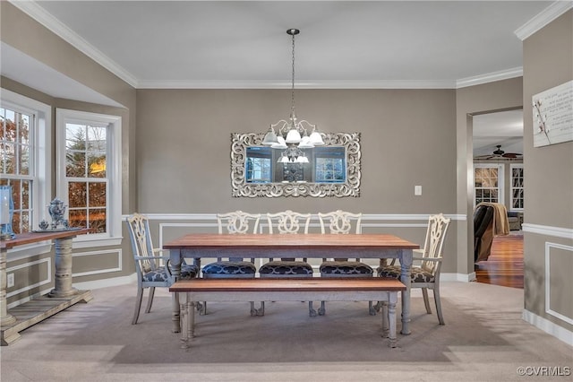 dining space with crown molding, carpet floors, and a notable chandelier