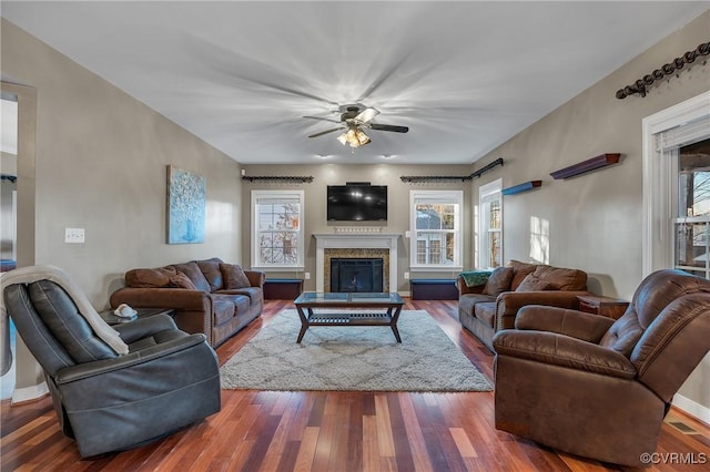 living room with a barn door, ceiling fan, and dark hardwood / wood-style floors