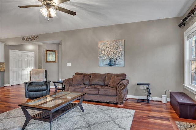 living room with dark hardwood / wood-style floors and ceiling fan