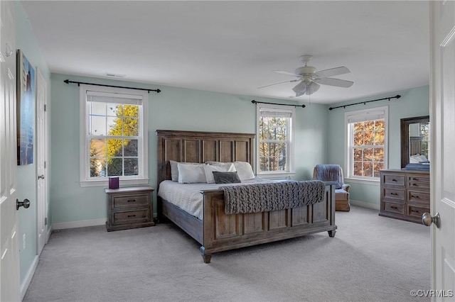 bedroom featuring light colored carpet and ceiling fan