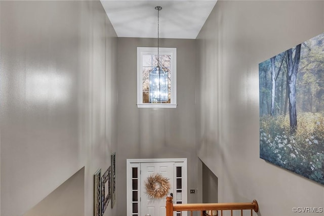 stairway with a chandelier