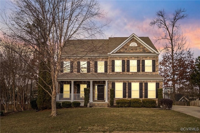 view of front of home with a lawn and a porch