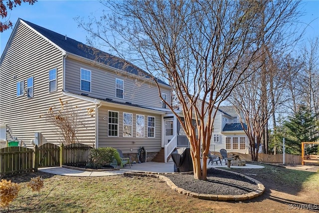 rear view of house with a yard and a patio area