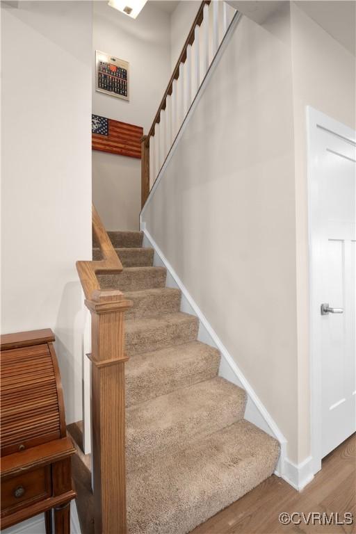 stairway featuring hardwood / wood-style floors