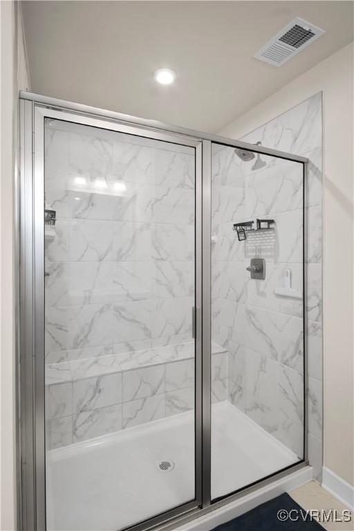 bathroom featuring tile patterned floors and an enclosed shower