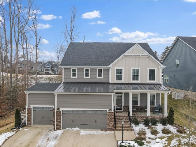 view of front of house featuring covered porch, a wall mounted AC, and a garage