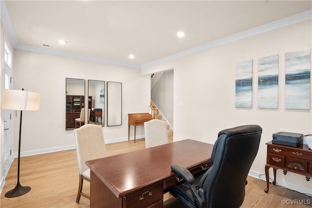 home office with crown molding and light wood-type flooring