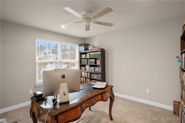 carpeted office space with plenty of natural light and ceiling fan