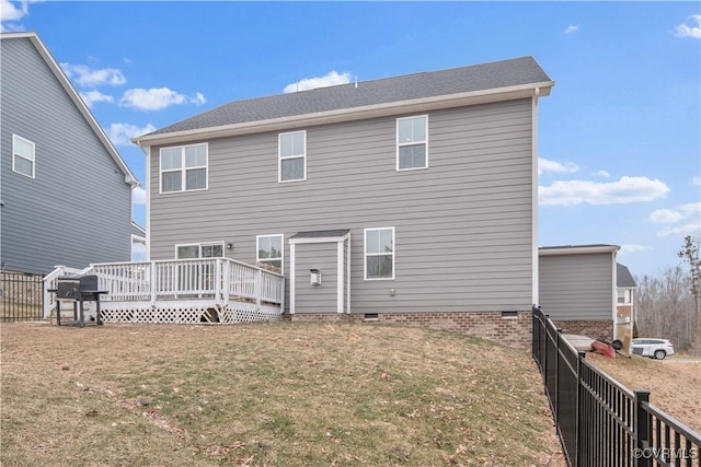 back of house featuring a wooden deck and a yard