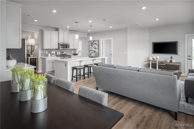 living room with light hardwood / wood-style flooring