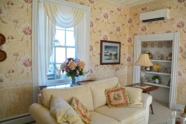 sitting room featuring a baseboard heating unit and a wall mounted air conditioner