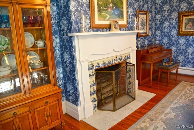 sitting room featuring a fireplace and wood-type flooring