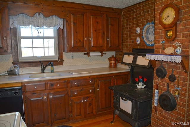 kitchen with sink, dishwasher, and light hardwood / wood-style flooring