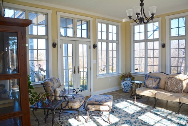 sunroom / solarium with an inviting chandelier and french doors