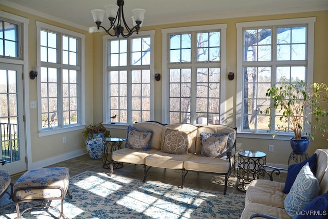 sunroom / solarium featuring a notable chandelier