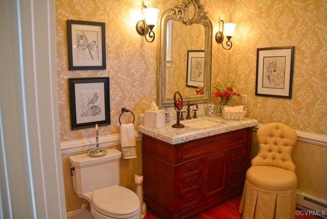 bathroom with a baseboard radiator, toilet, and vanity