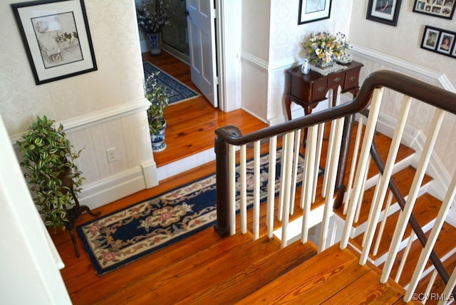 stairway with hardwood / wood-style flooring