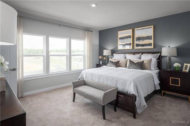 bedroom with light carpet and multiple windows