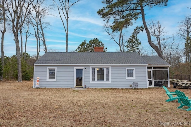 view of front of house with a sunroom and a front yard