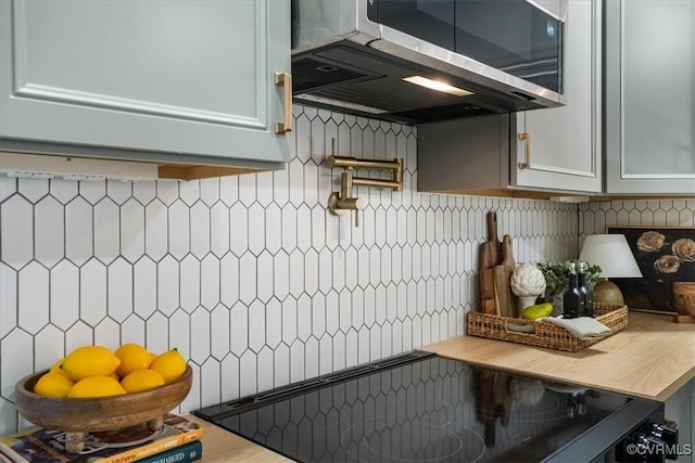 kitchen with range, ventilation hood, and backsplash