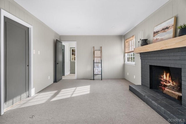 carpeted living room with a brick fireplace and crown molding