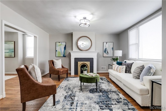 living room featuring hardwood / wood-style flooring and a fireplace