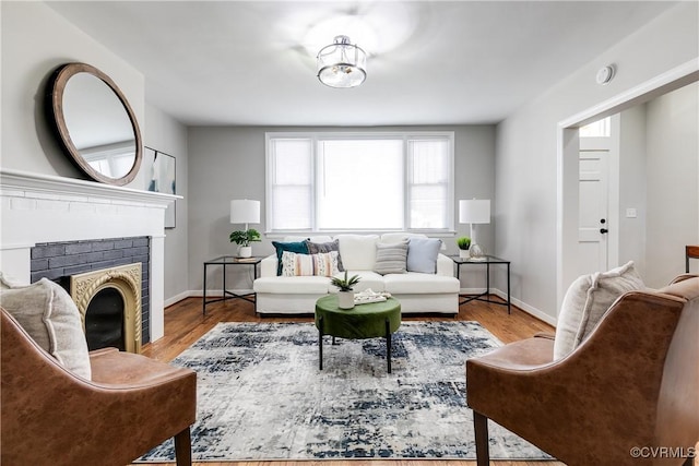 living room featuring wood-type flooring and a fireplace