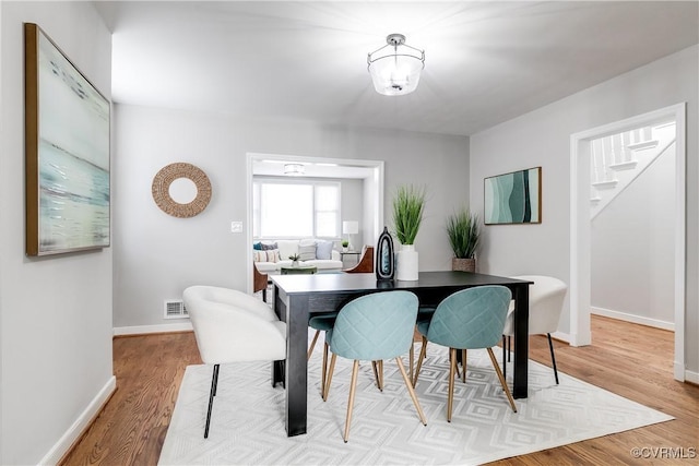 dining area featuring light wood-type flooring