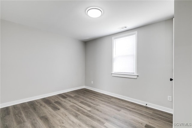 spare room featuring wood-type flooring