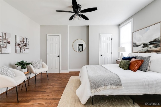 bedroom with dark wood-type flooring and ceiling fan