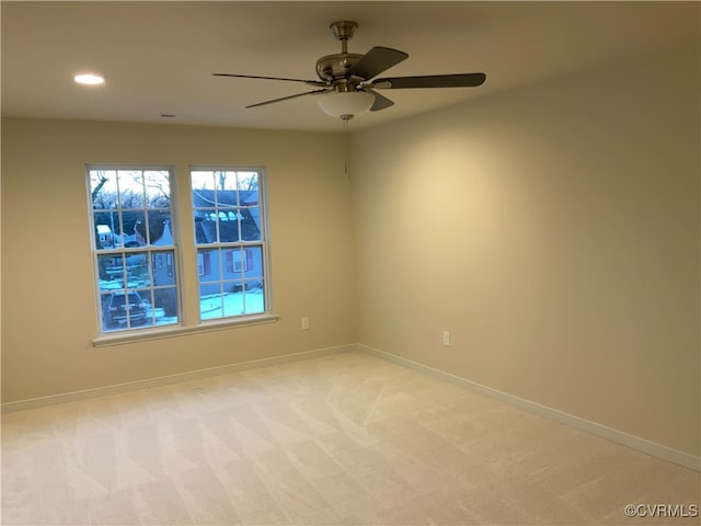 carpeted empty room featuring ceiling fan