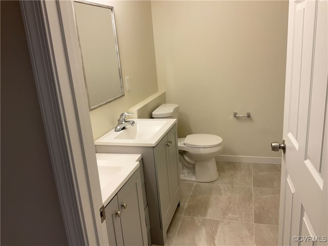 bathroom with vanity, tile patterned floors, and toilet