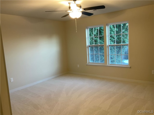 carpeted empty room featuring ceiling fan