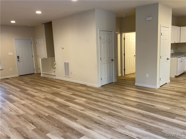 unfurnished living room featuring light hardwood / wood-style floors