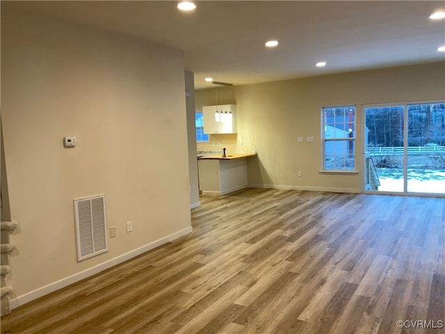 unfurnished living room featuring wood-type flooring