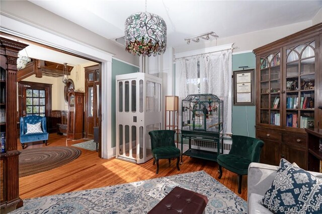 living area featuring an inviting chandelier and wood-type flooring