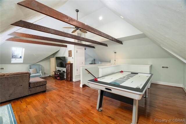 game room with hardwood / wood-style flooring, lofted ceiling with skylight, and ceiling fan