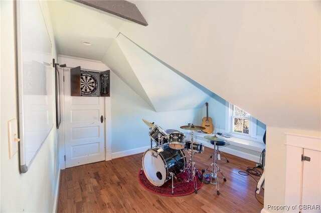 bonus room featuring hardwood / wood-style flooring and lofted ceiling with beams