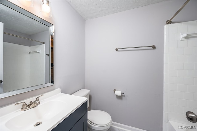 bathroom featuring toilet, a textured ceiling, and vanity