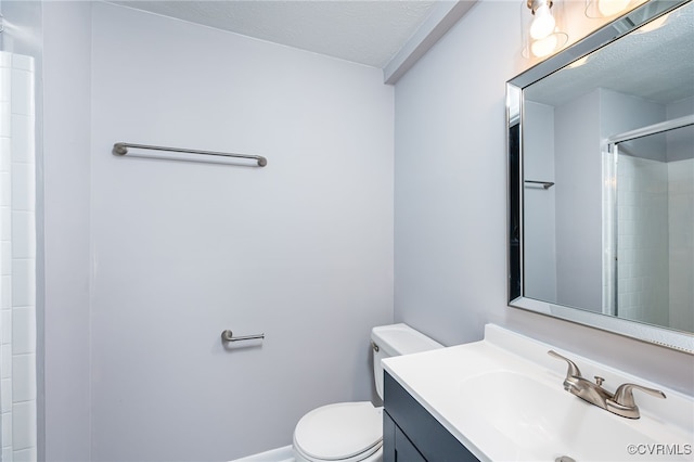 bathroom featuring a textured ceiling, toilet, an enclosed shower, and vanity