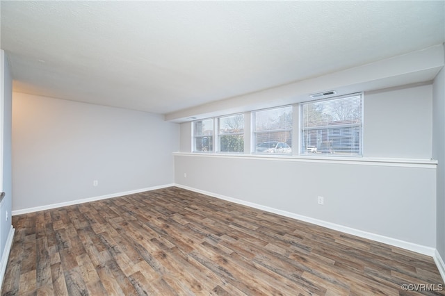 unfurnished room featuring dark hardwood / wood-style floors