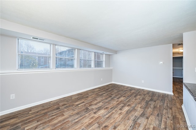 spare room featuring dark wood-type flooring