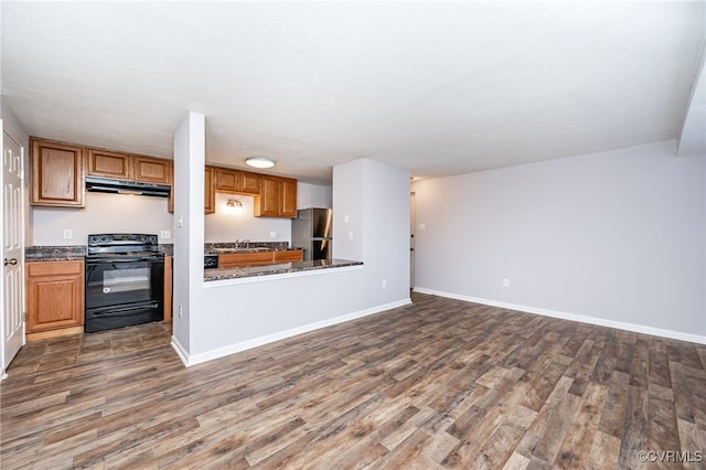 kitchen with dark hardwood / wood-style flooring, sink, black electric range oven, kitchen peninsula, and stainless steel refrigerator